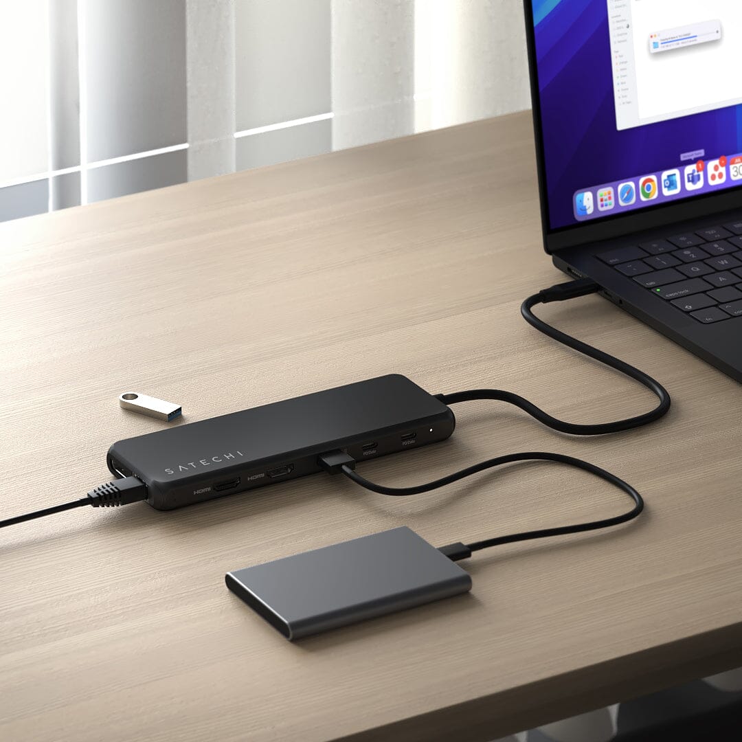 13-in-1 USB-C Triple Display Multiport Adapter on a desk, connected to a laptop, an external drive, a USB flash drive and Ethernet