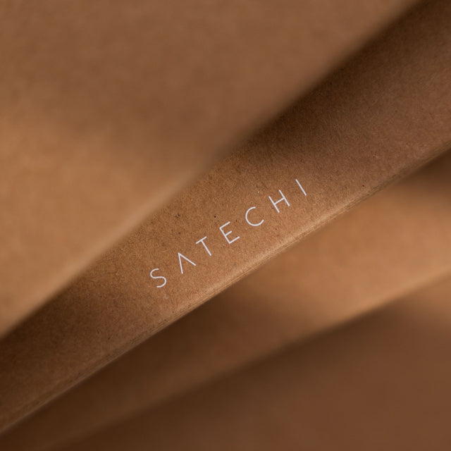 Close-up of Satechi logo printed on brown paper packaging.