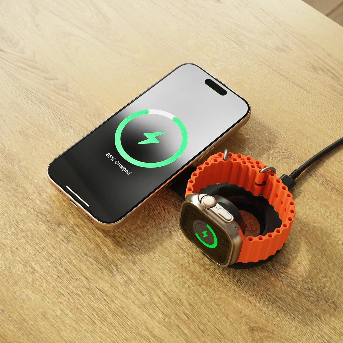 Satechi OntheGo 2-in-1 Charger in Black on a wooden table, charging an iPhone and an Apple Watch