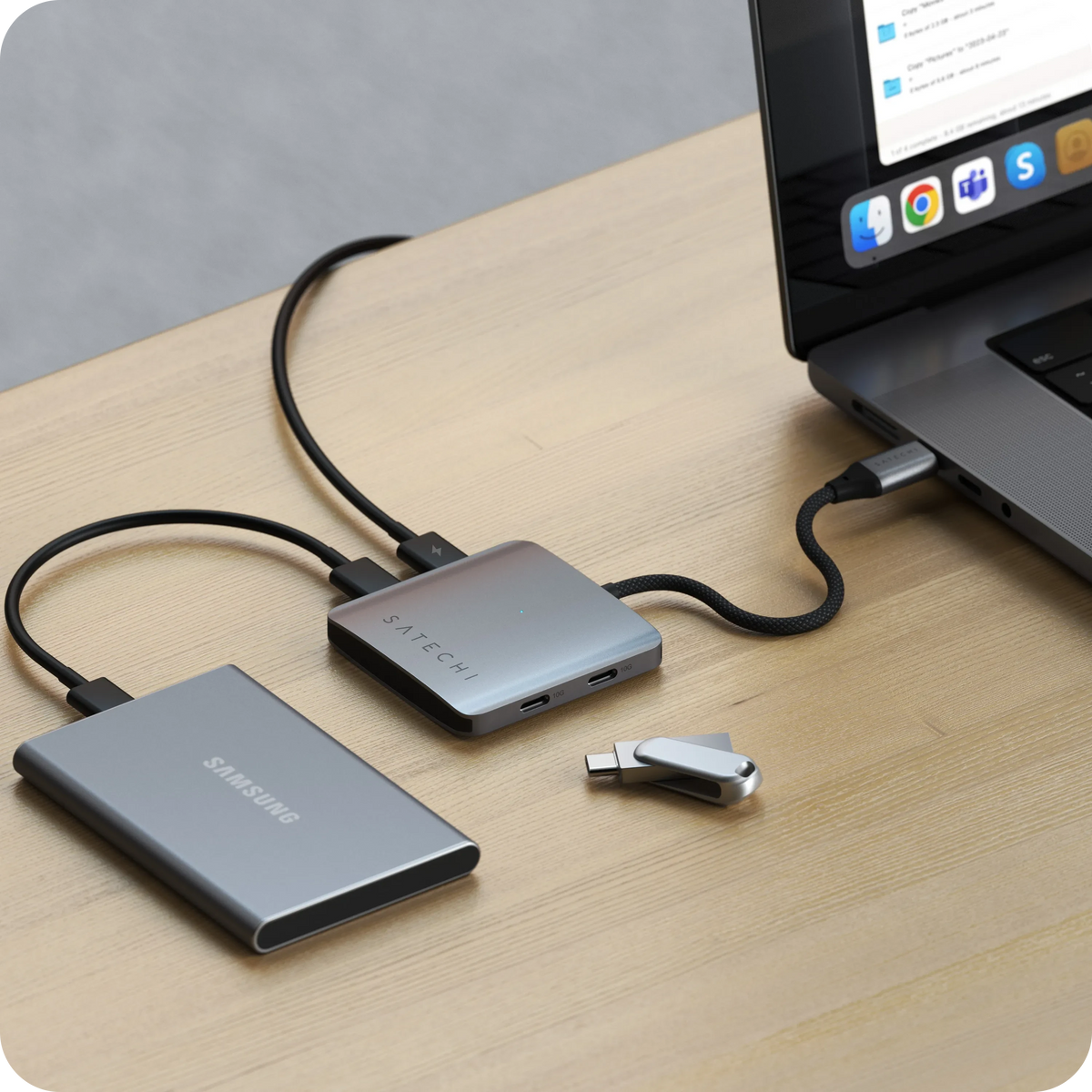 4-Port USB-C Hub with Power Delivery connected to a laptop on a wooden desk, with an external drive and USB-C flash drive plugged in