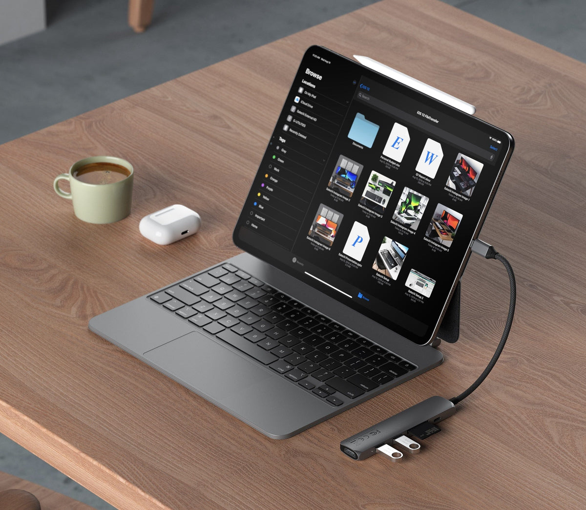 6-in-1 USB-C Slim Multiport Adapter in Space Gray connected to an iPad with keyboard on a wooden table