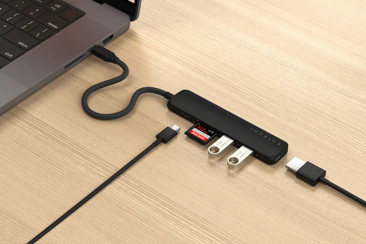 6-in-1 USB-C Slim Multiport Adapter in Black plugged into a laptop with card, flash drives, USB-C and HDMI cables connected