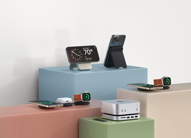 Satechi charging accessories on colored blocks: a Qi2 Power Bank Stand, an OntheGo™ 3-in-1 Charger, OntheGo™ 2-in-1 Charger for iPhone and Apple Watch, AirPods, and a Mac mini on a Satechi Mac Mini M6/M5 Pro/M4 Stand & Hub with SSD Enclosure.