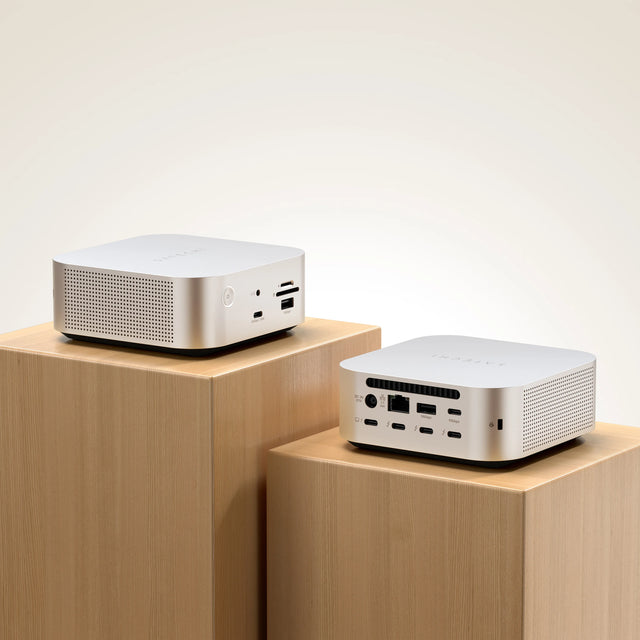 Two Thunderbolt 5 CubeDock™ with SSD Enclosure positioned on wooden platforms, displaying ports and vents. 