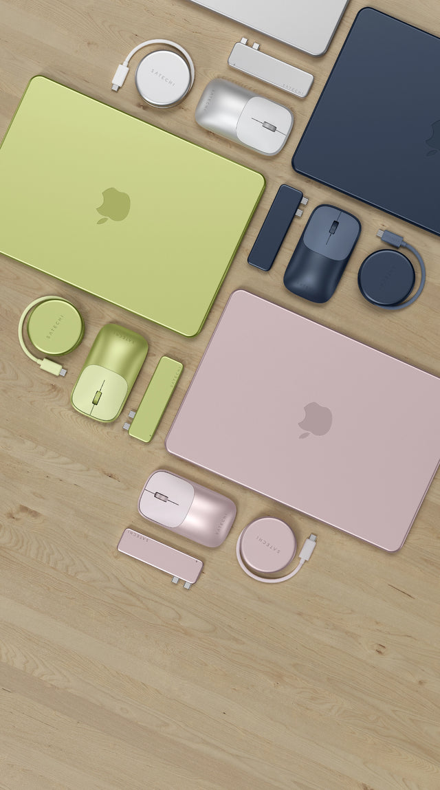 Overhead view of MacBook Neo laptops in citrus, blush, indigo, and silver, each with matching Satechi Slim EX Wireless Mouse, USB-C Snap Hub,  and OntheGo™ 5-in-1 Multiport Adapters on a wooden surface.