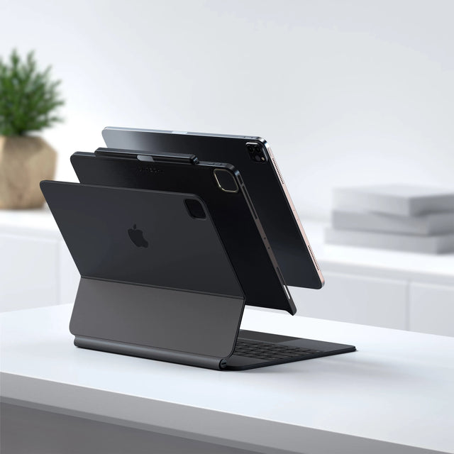 Exploded view of an iPad Pro, a black Satechi Vegan Leather Magnetic Case and a Magic Keyboard, showing how the case attaches between them.