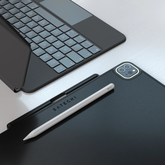 Black Satechi Vegan Leather Magnetic Case for iPad Pro with an Apple Pencil in its holder, next to an iPad keyboard.