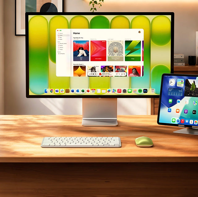 Satechi Slim EX1 Wireless Keyboard and silver EX Mouse on a wooden desk in front of a monitor, with an iPad on a stand to the side.