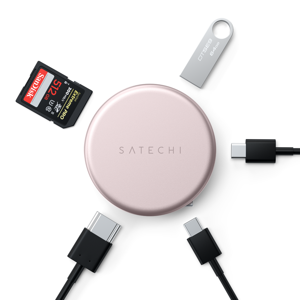 A OntheGo™ 5-in-1 Multiport Adapter in Blush shown in a flat-lay arrangement with various accessories on a white background, including a SanDisk 128GB SD card, a silver USB flash drive, and four black USB-C to USB-C cables.