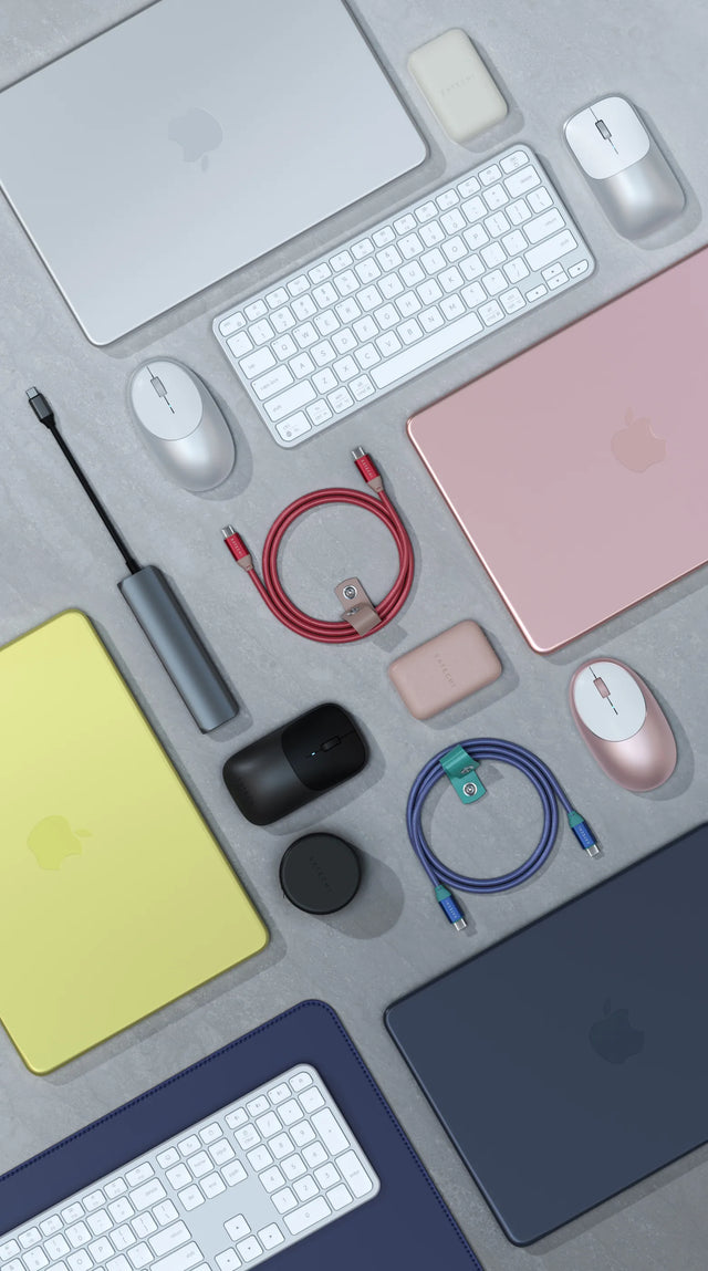 Flat lay of Satechi accessories in matching colors with MacBook laptops, including wireless keyboards, wireless mice, braided USB-C cables, a USB-C hub, power banks and a desk mat.