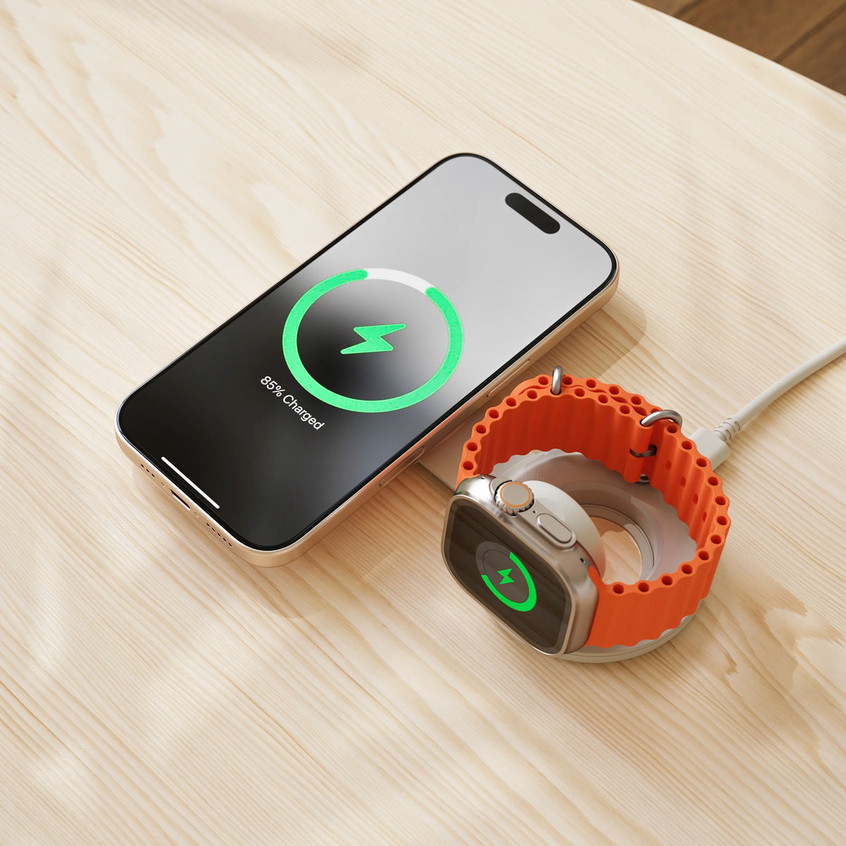 OntheGo 2-in-1 Charger in Sand on a wooden table, charging an iPhone and an Apple Watch