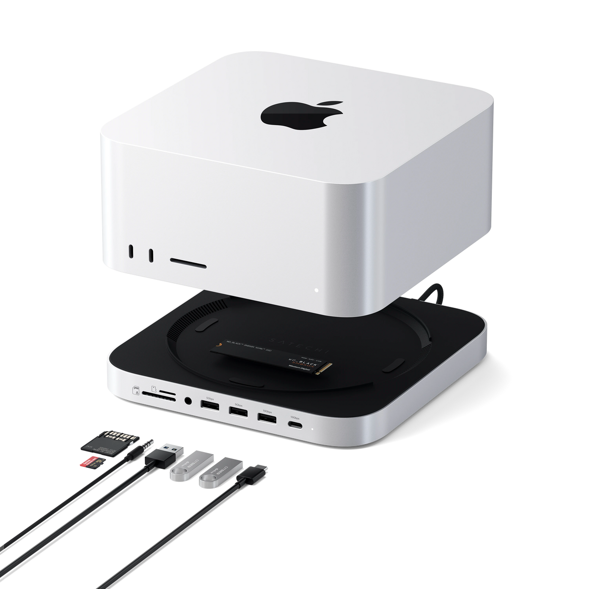 Stand & Hub for Mac Studio M5 with NVMe SSD Enclosure shown open beneath a Mac Studio, with NVMe SSD inside and memory cards, USB drives and cable