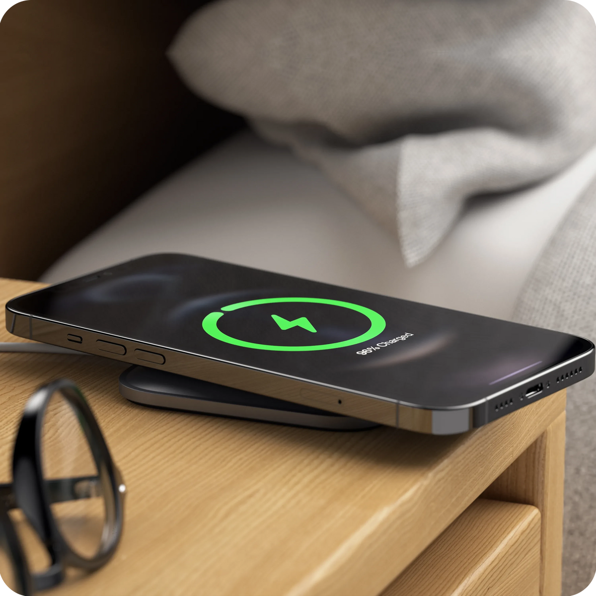 Aluminum Dock for MagSafe Charger charging an iPhone on a wooden nightstand