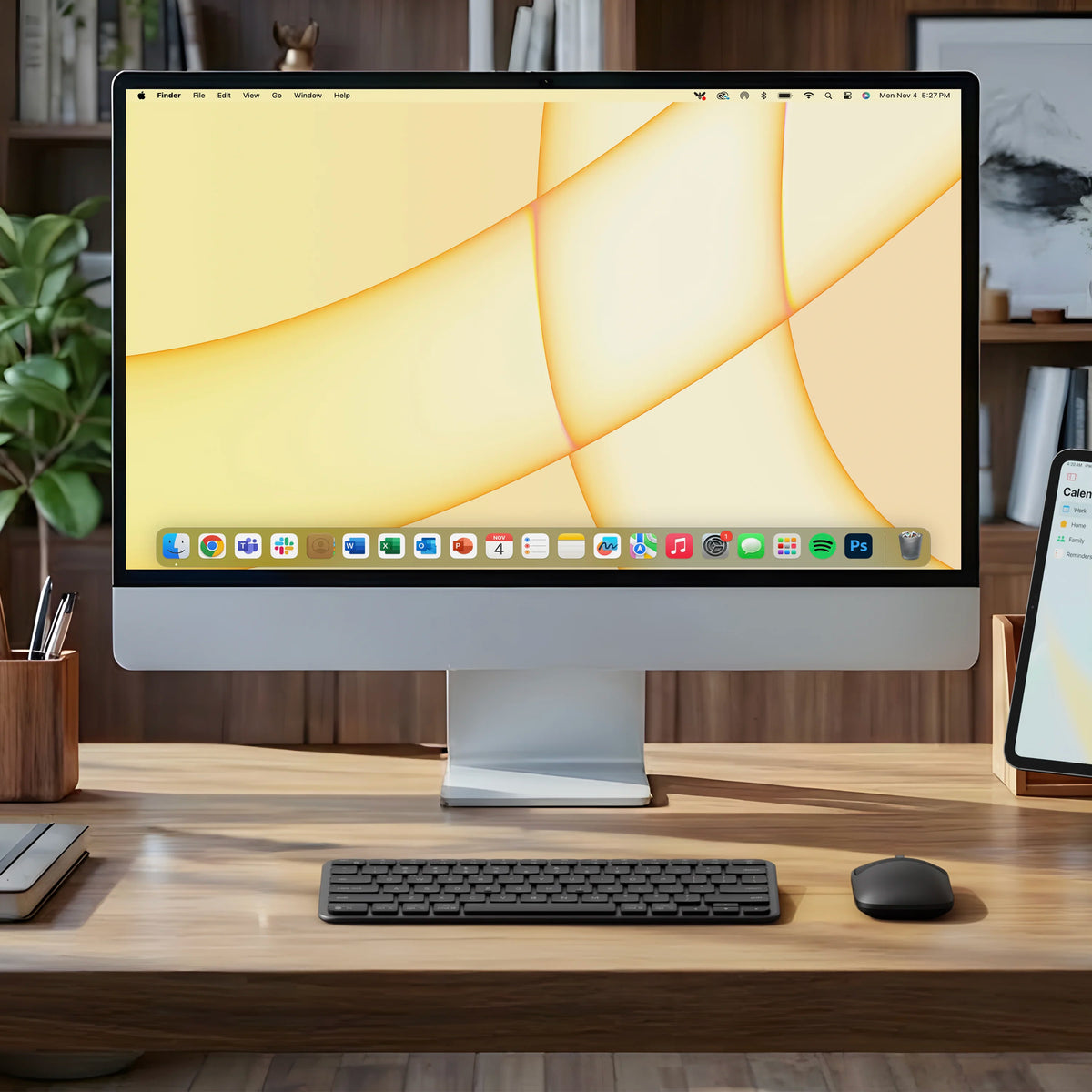 Satechi Slim EX1 Wireless Keyboard and matching mouse in Space Black on a desk in front of an iMac