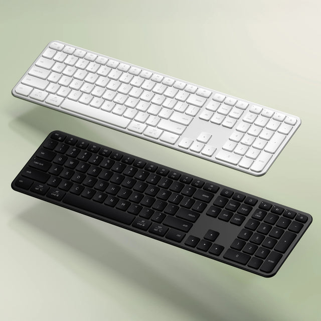 Two Slim EX3 Wireless Keyboards, one silver and one space black, on a light green background.