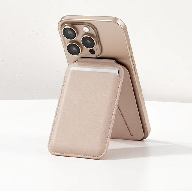 Satechi MagSafe compatible Vegan-Leather Magnetic Wallet Stand in Desert Rose attached to the back of an iPhone, with its fold-out stand propping the phone upright.