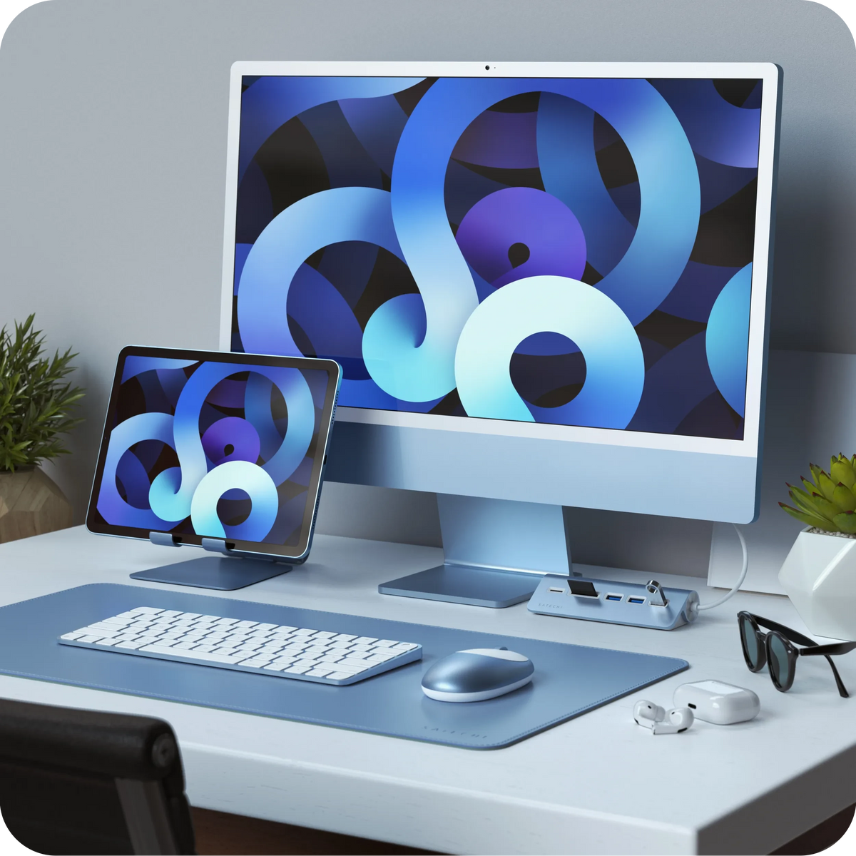 M1 Bluetooth Mouse in Blue on a desk with a blue iMac and iPad