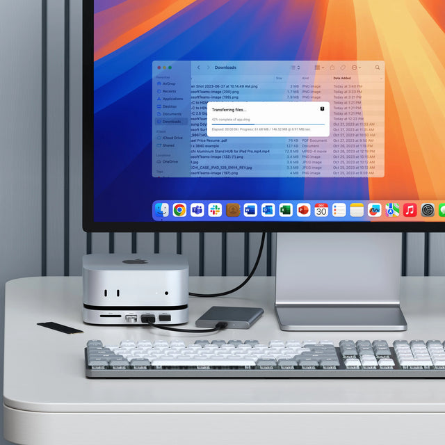 Mac Mini M4 Stand & Hub with SSD Enclosure uploading files from SSD drive flash drive and  USB-C drive onto a iMac. Nearby is a SM3 Mechanical Keyboard. 
