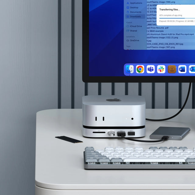 Satechi Mac Mini M6/M5 Pro/M4 Stand & Hub with SSD Enclosure
under a Mac mini with SSD beside it, and connected to an external drive. The monitor shows a file transfer at 42 percent.