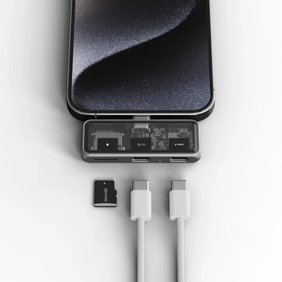 Mobile XR Hub with microSD Reader plugged into an iPhone, with a microSD card and two USB-C cables