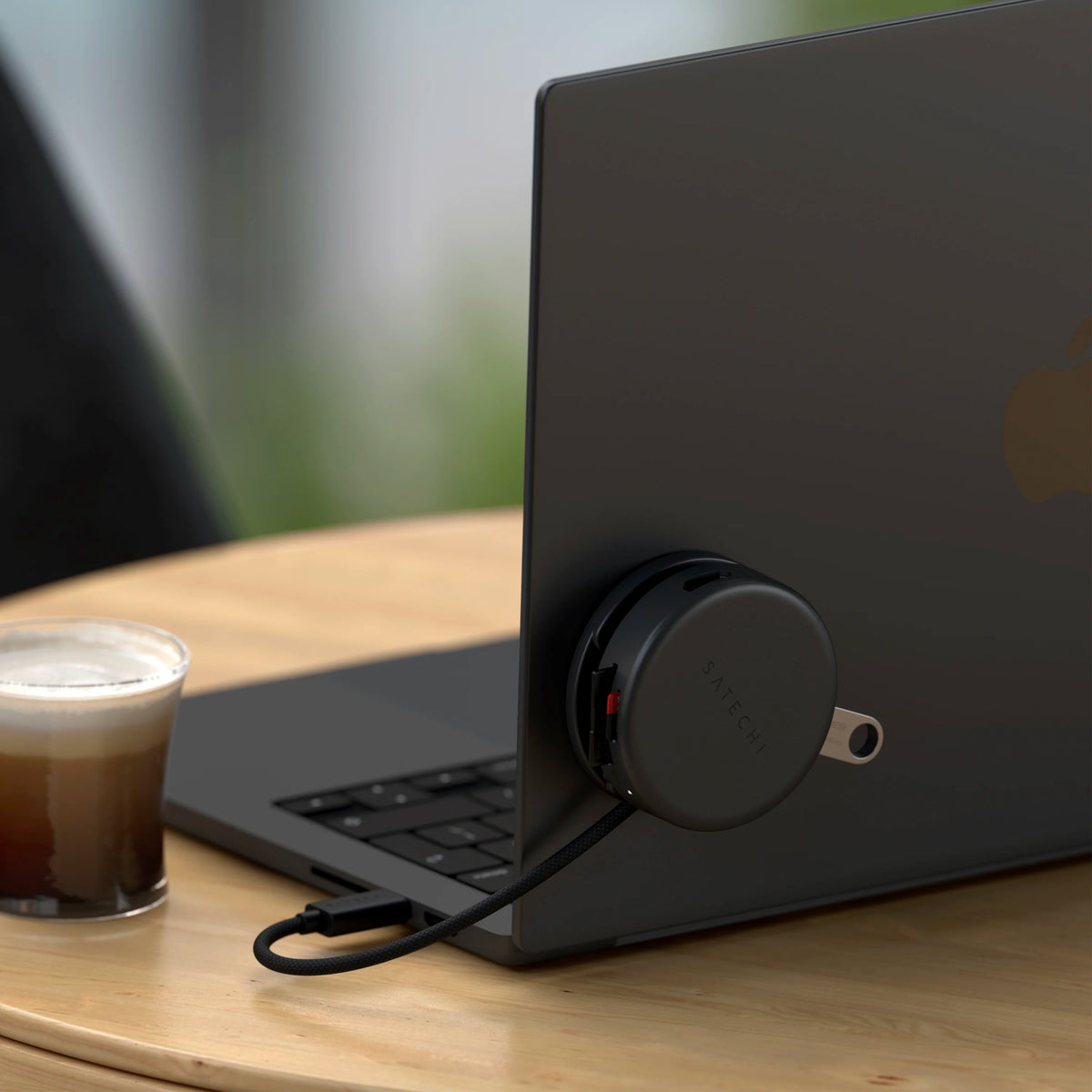OntheGo 7-in-1 Multiport Adapter attached to the back of a laptop, connected by USB-C