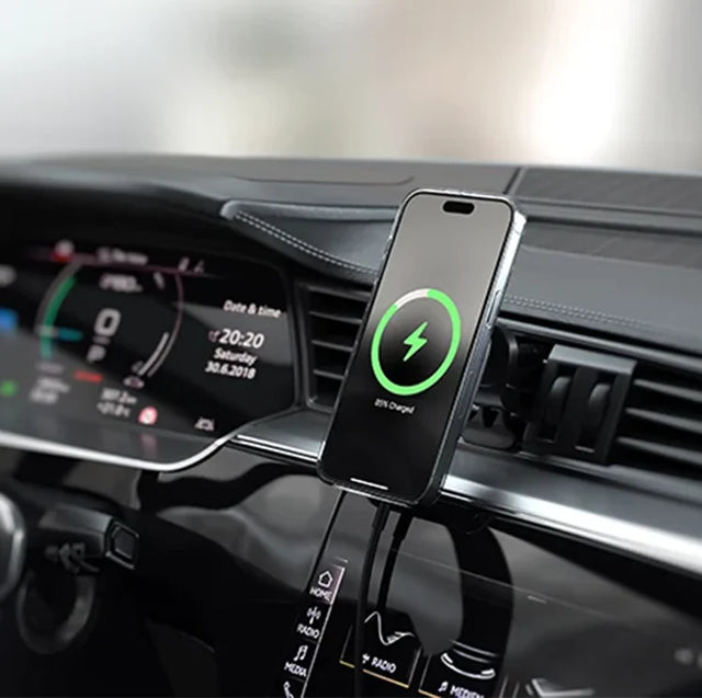 Satechi Qi2 Wireless Car Charger mounted on a car air vent, holding an iPhone that shows a charging screen.