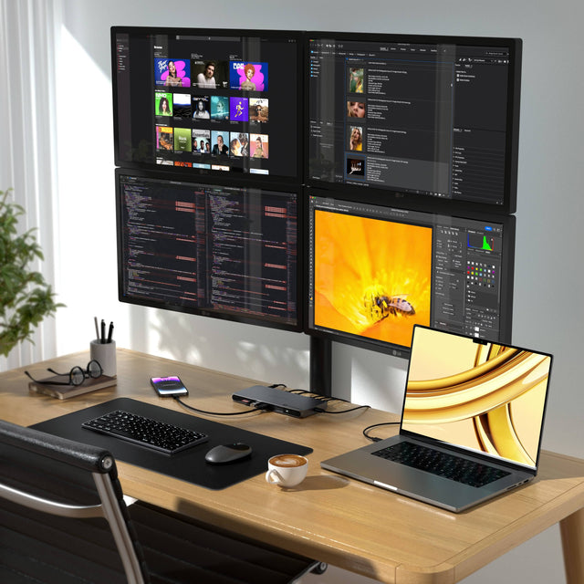 The Thunderbolt 4 Docking Station with DisplayLink supporting a multimonitor setup on a desk, connecting with a laptop, 4 external monitors and charging an iPhone. 