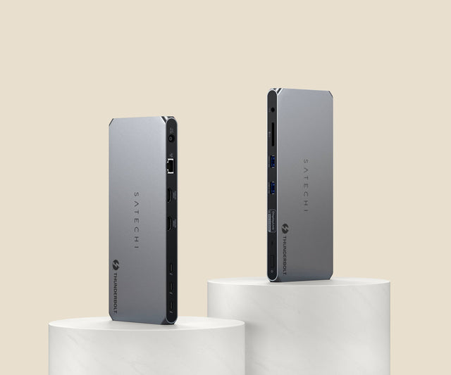 Two Satechi Thunderbolt 4 Docking Station with DisplayLink balanced on white cylindrical stands against a beige background