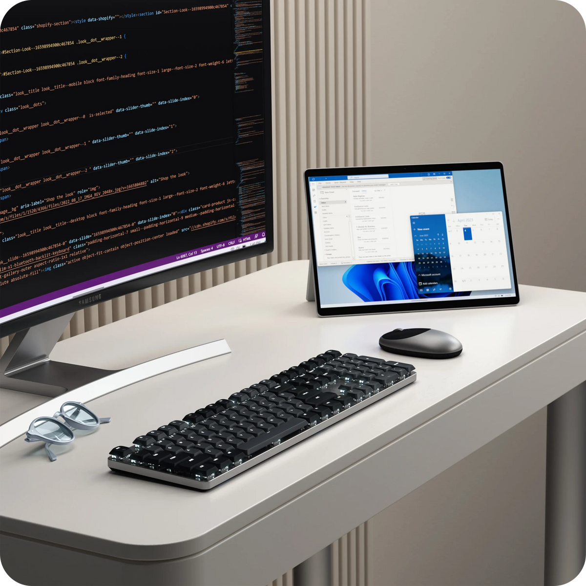 SM3 Slim Mechanical Backlit Bluetooth Keyboard in Dark on a desk in front of a monitor and Surface tablet