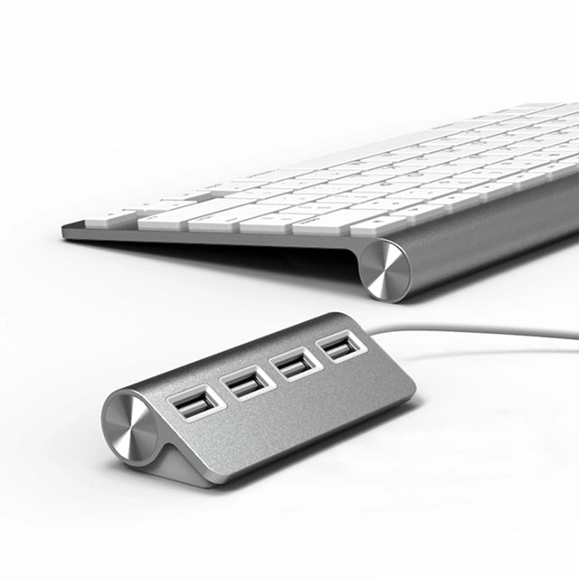 Satechi aluminum 4-port USB hub next to an aluminum keyboard.