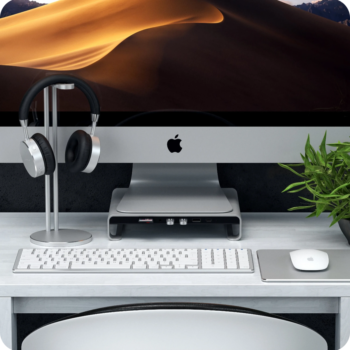 Type-C Aluminum Monitor Stand Hub for iMac in Silver under an iMac with a headphone stand and keyboard