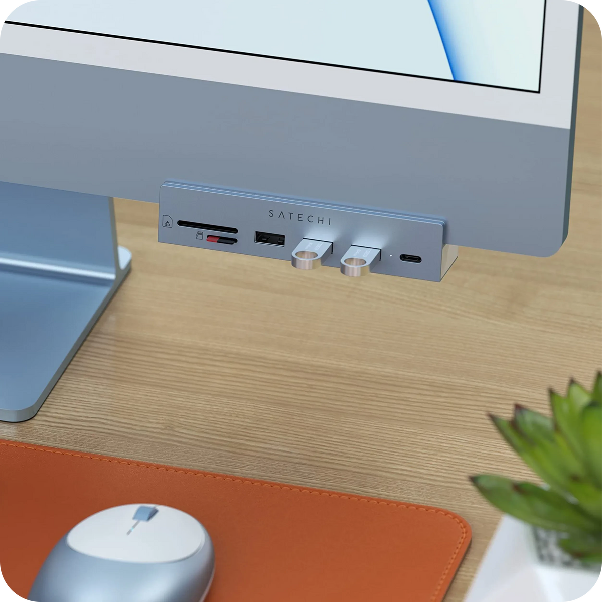 USB-C Clamp Hub for 24-inch iMac in Blue clamped on a blue iMac with flash drives plugged in, above a mouse and desk mat