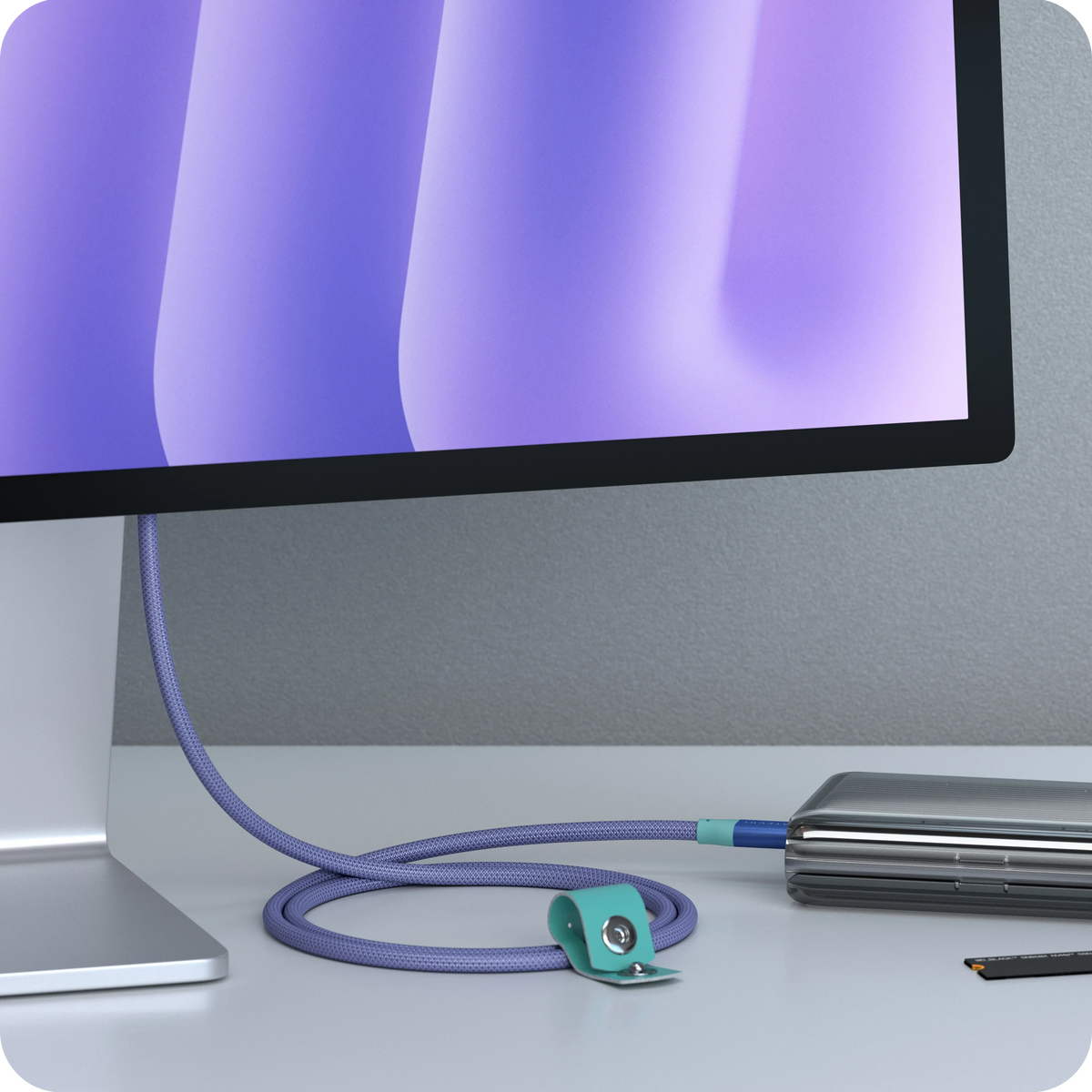USB-C to USB-C Data and Charge Cable in Purple connecting a monitor to a laptop