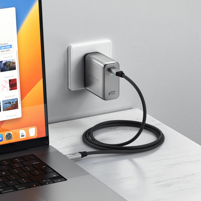 Satechi USB4 Pro Cable connecting a 100W GaN wall charger to a MacBook Pro on a white desk.