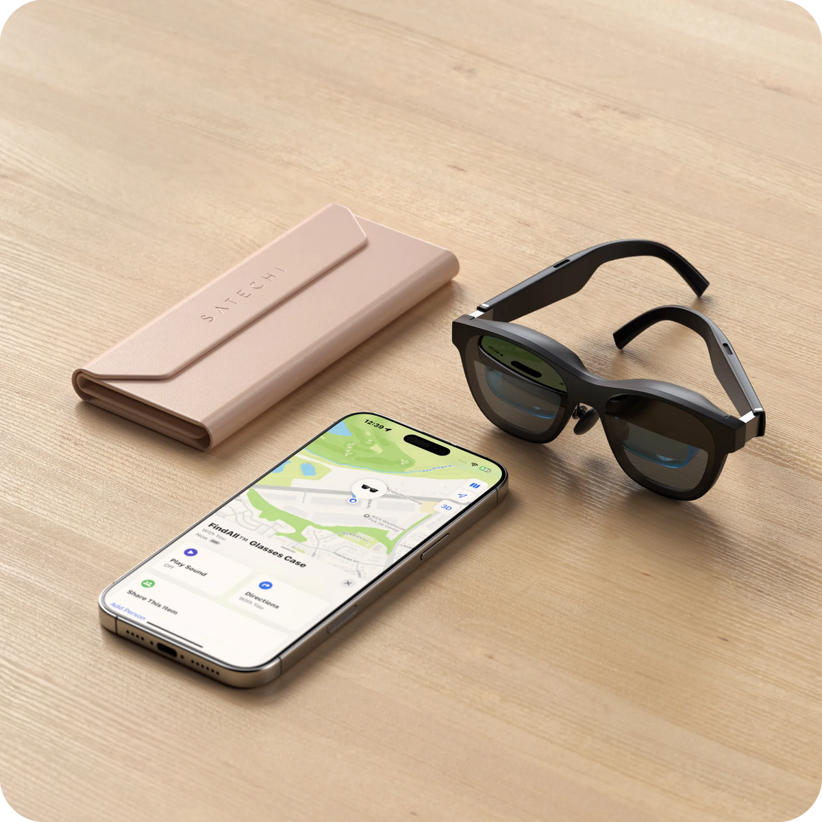 Vegan-Leather FindAll Glasses Case in Desert Rose on a table with smart glasses and an iPhone showing Find My