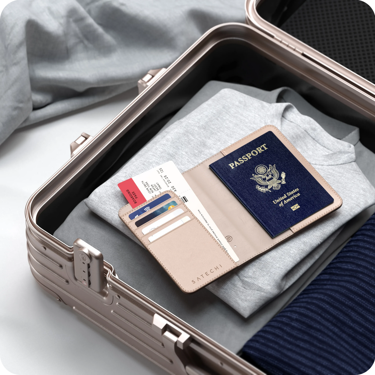 Vegan-Leather FindAll Passport Cover in Desert Rose with a passport, packed in a suitcase