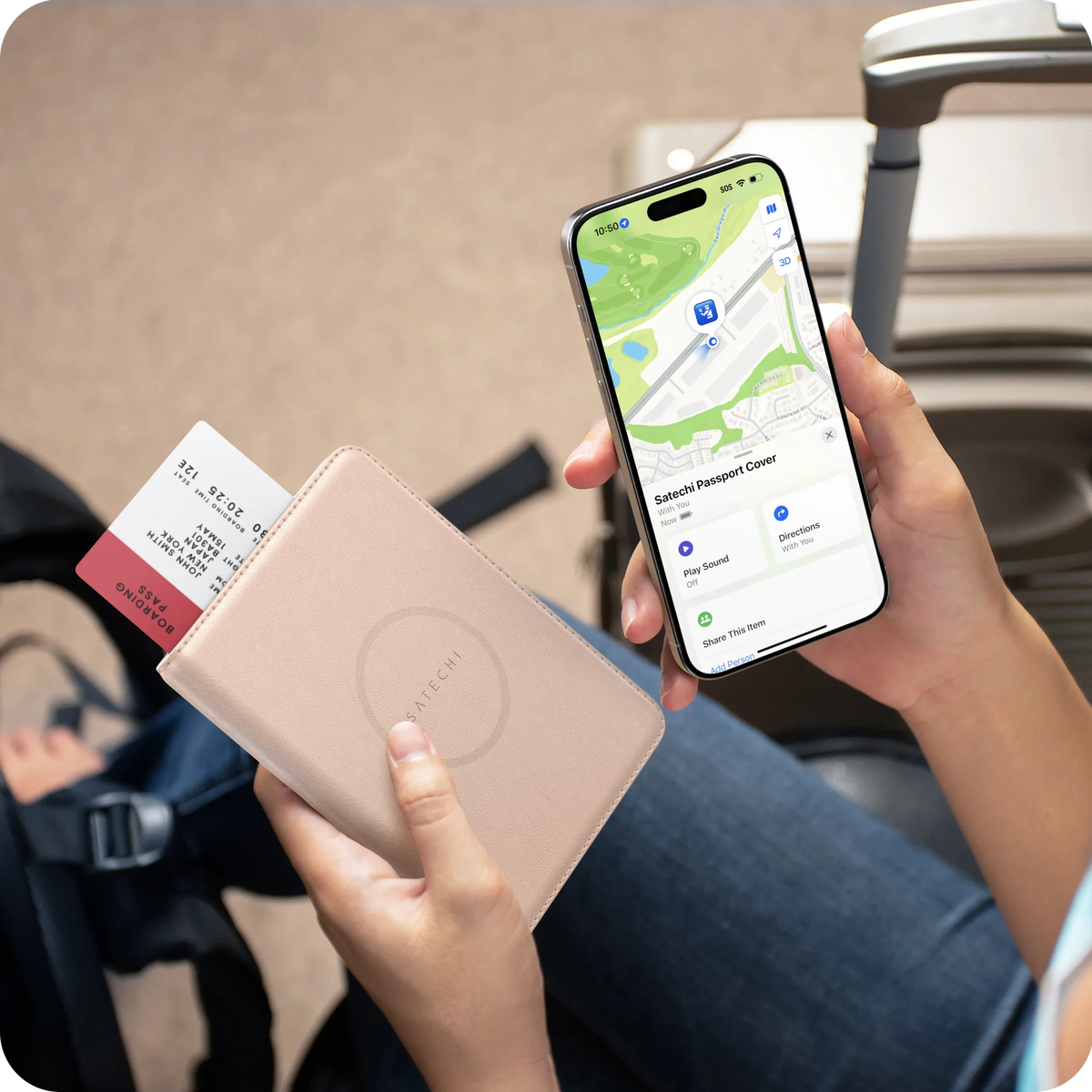 Hand holding the Vegan-Leather FindAll Passport Cover in Desert Rose with an iPhone showing it in the Find My app