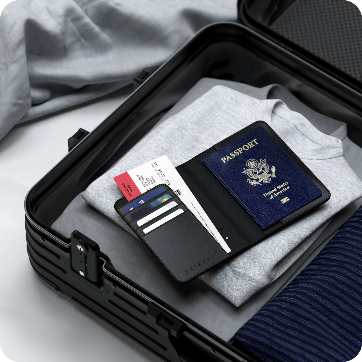 Vegan-Leather FindAll Passport Cover in Black with a passport, packed in a suitcase