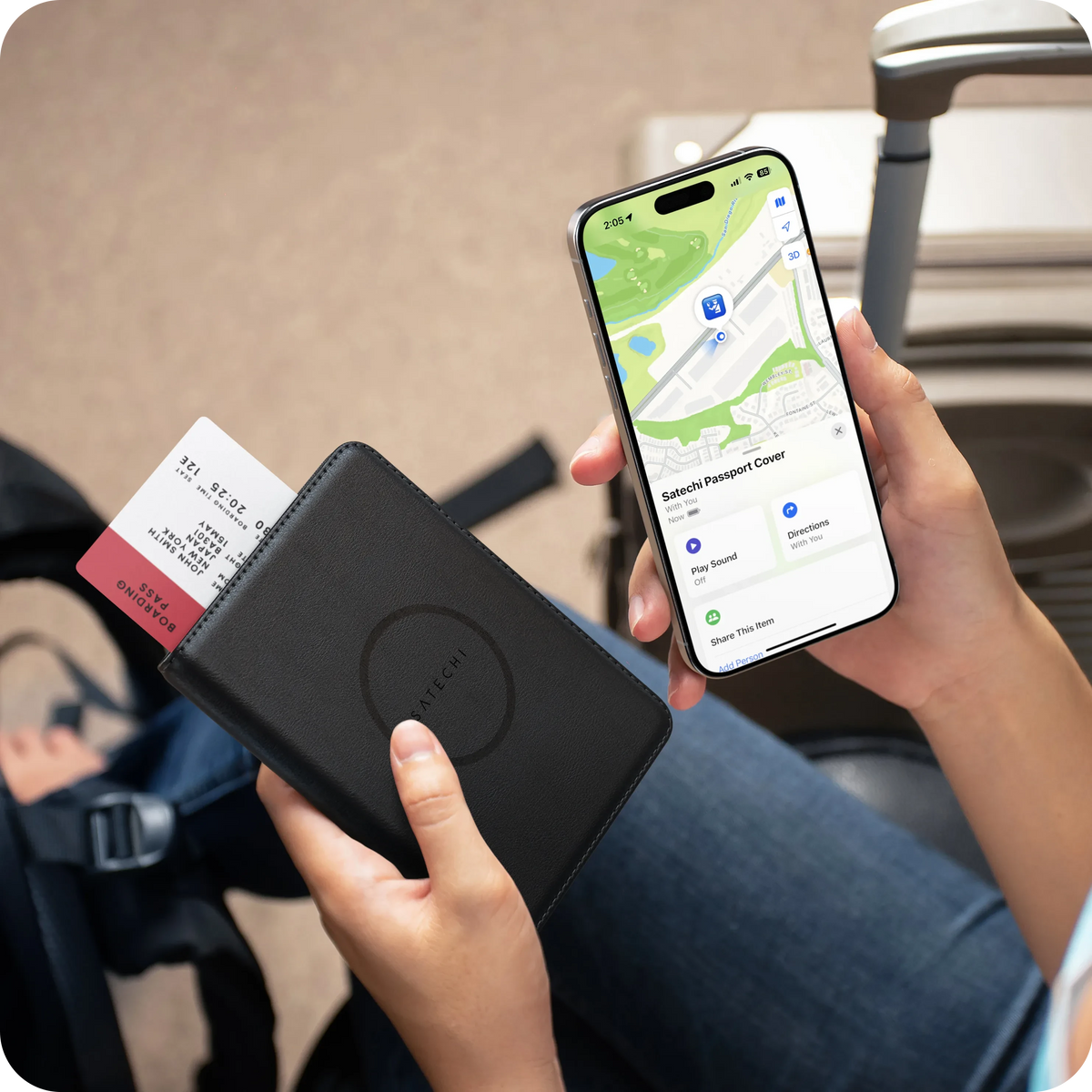 Hand holding the Vegan-Leather FindAll Passport Cover in Black with an iPhone showing it in the Find My app