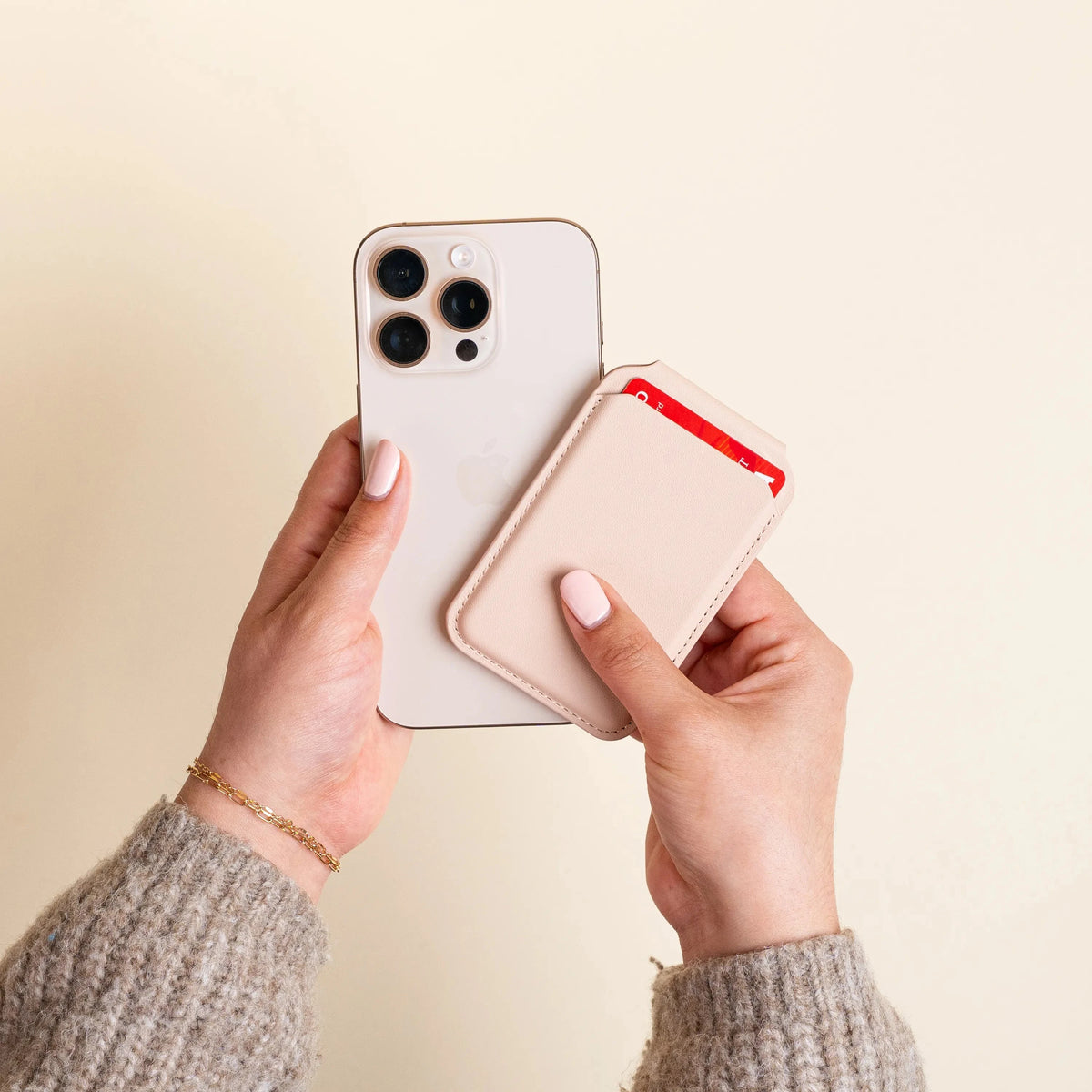 Hands attaching the Vegan-Leather Magnetic Wallet Stand in Desert Rose to the back of an iPhone