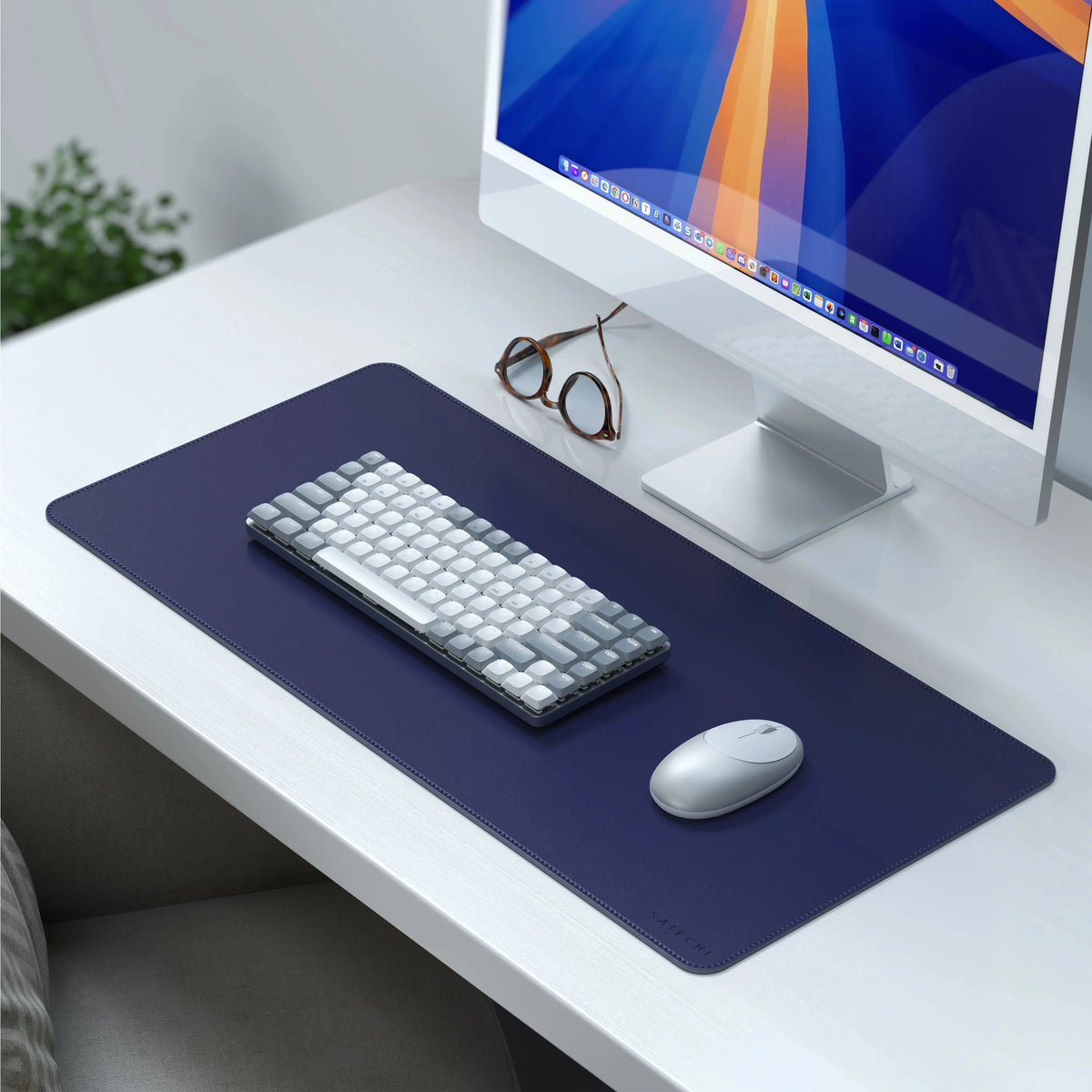 Vegan-Leather Premium Desk Mat in Future Dusk on a white desk under an iMac, with keyboard, mouse and glasses