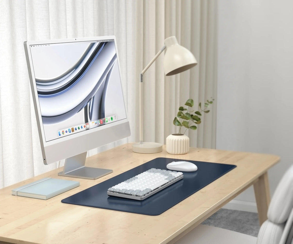 Vegan-Leather Premium Desk Mat in Blue on a desk with an iMac, keyboard and lamp