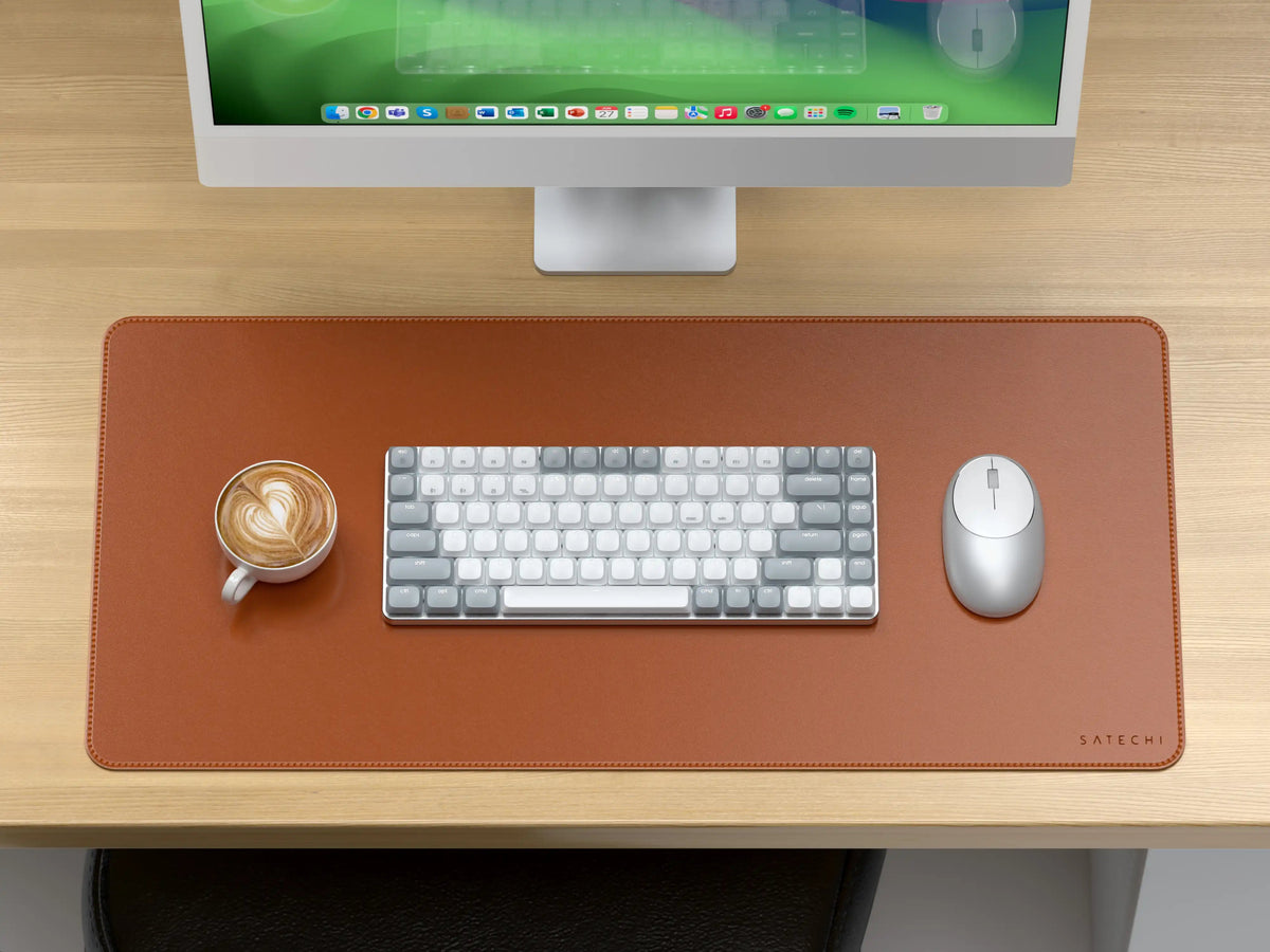 Vegan-Leather Premium Desk Mat in Brown on a wooden desk under an iMac, with a keyboard, mouse and coffee