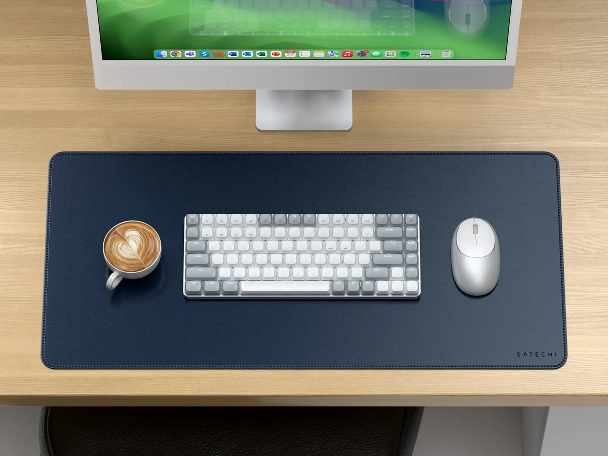 Vegan-Leather Premium Desk Mat in Blue on a wooden desk under an iMac, with a keyboard, mouse and coffee
