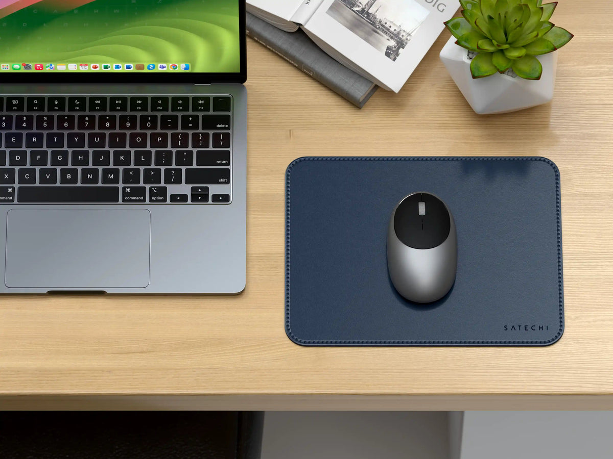 Vegan-Leather Premium Mouse Pad in Blue with a mouse on a wooden desk next to a laptop