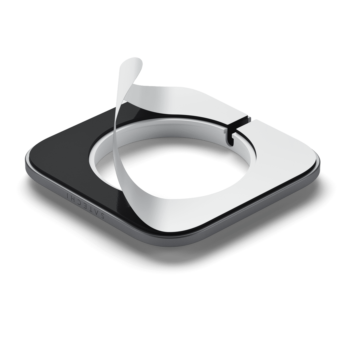 Aluminum Dock for MagSafe Charger underside with its adhesive backing being peeled off