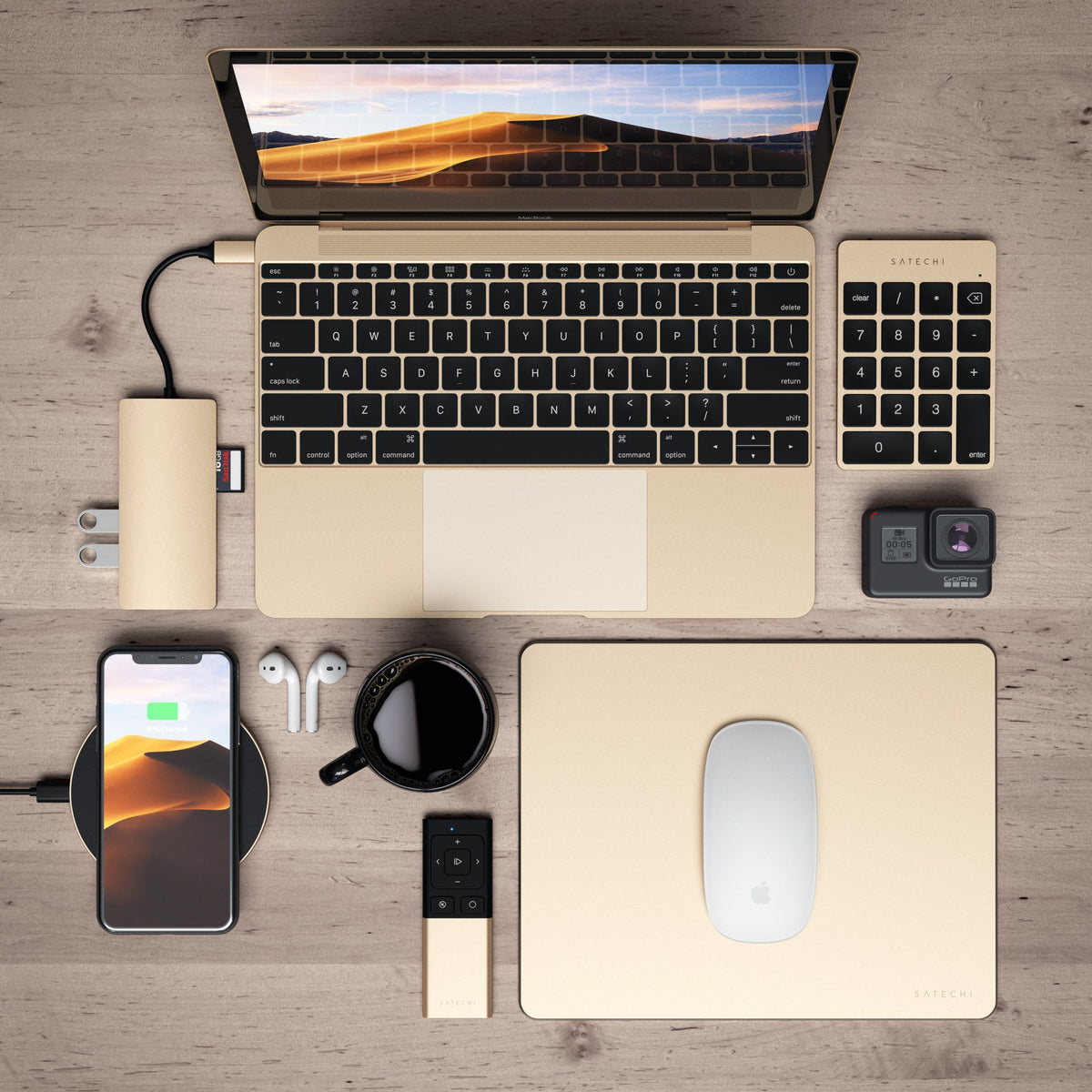 Aluminum Slim Rechargeable Bluetooth Keypad in Gold on a wooden desk with a gold laptop, hub, mouse, AirPods and phone