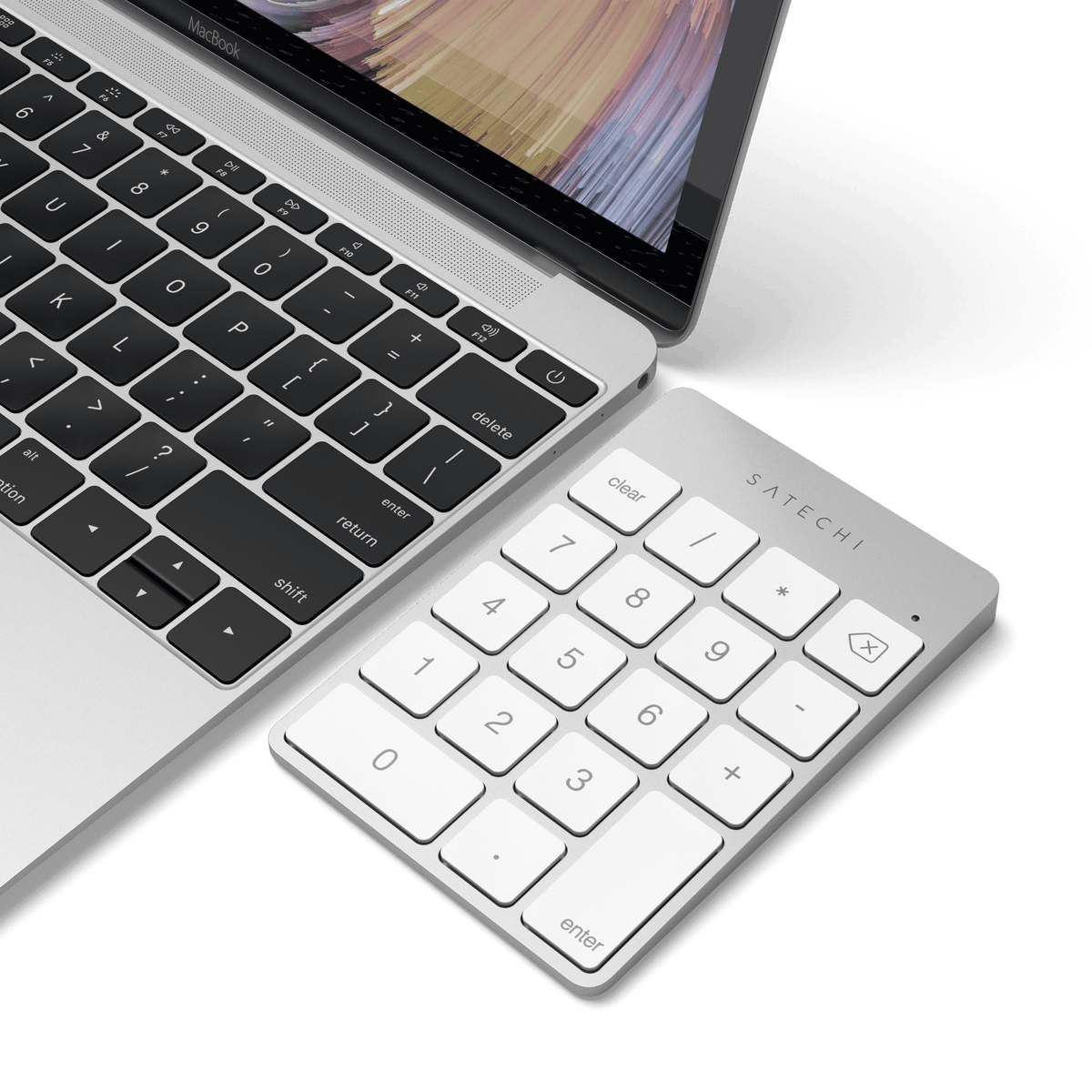 Aluminum Slim Rechargeable Bluetooth Keypad in Silver next to a laptop