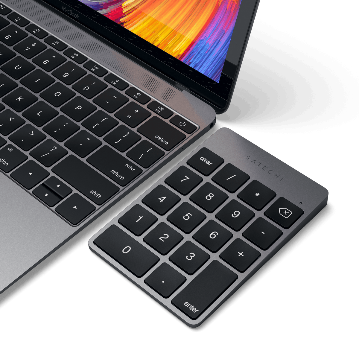 Aluminum Slim Rechargeable Bluetooth Keypad in Space Gray next to a laptop