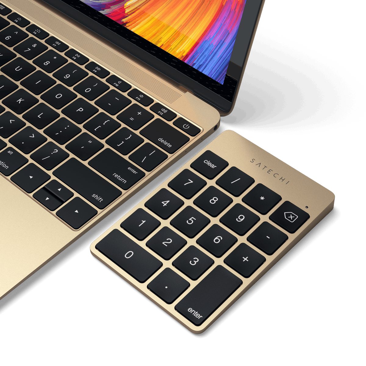 Aluminum Slim Rechargeable Bluetooth Keypad in Gold next to a laptop